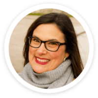 a woman wearing glasses and a scarf